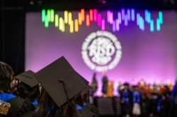 View from behind of students assembled at a RISD Commencement ceremony