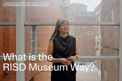 RISD Museum Director Tsugumi Maki in a gladd corrdior connecting museum buildings
