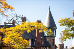 Image of Carr House roofline on campus amid fall foliage