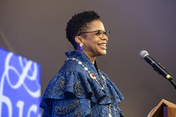 RISD President Crystal Williams speaks at a podium during her inauguration ceremony