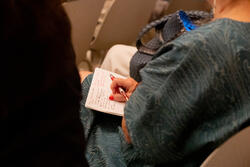 closeup of a person actively taking notes on paper